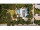 Aerial view showing house, pool, large backyard, and surrounding trees at 9400 93Rd St, Seminole, FL 33777