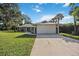 Single story home with gray siding and attached garage at 700 Dolphin Rd, Venice, FL 34293