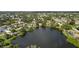 Aerial view of waterfront property, showcasing surrounding houses and lush landscape at 700 Dolphin Rd, Venice, FL 34293