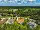 An aerial view showcasing the property's setting amidst a lush, green landscape and community amenities at 14526 17Th E Ave, Bradenton, FL 34212