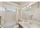 Bathroom featuring a tub and shower combination with a large mirror over the sink at 14526 17Th E Ave, Bradenton, FL 34212