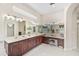 Bright bathroom featuring a large vanity with dual sinks, decorative lighting, and modern fixtures at 14526 17Th E Ave, Bradenton, FL 34212