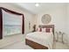 Bedroom featuring natural light, a bed with decorative pillows, and a small side table at 14526 17Th E Ave, Bradenton, FL 34212