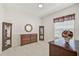Well-lit bedroom with carpet, a window, a wood dresser, mirror and display cabinets at 14526 17Th E Ave, Bradenton, FL 34212