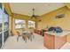 Covered patio includes a dining table, outdoor kitchen with a grill, and a ceiling fan at 14526 17Th E Ave, Bradenton, FL 34212
