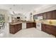 Open kitchen with granite counters, wood cabinets, and tile flooring overlooking the living area at 14526 17Th E Ave, Bradenton, FL 34212