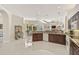 Open kitchen with granite counters, wood cabinets, and tile flooring overlooking the living area at 14526 17Th E Ave, Bradenton, FL 34212
