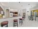 Kitchen with granite counters, bar seating, and tile flooring with dining room view at 14526 17Th E Ave, Bradenton, FL 34212