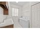 Well-lit laundry room features a sink, counter space, shelving, and a washer and dryer at 14526 17Th E Ave, Bradenton, FL 34212