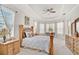 Well-lit main bedroom with a tray ceiling, decorative accents, bay windows, and a sitting area at 14526 17Th E Ave, Bradenton, FL 34212