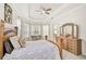 Spacious main bedroom featuring a tray ceiling, natural light, and decorative wooden furniture at 14526 17Th E Ave, Bradenton, FL 34212