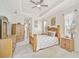 Comfortable main bedroom with a tray ceiling, decorative wooden furniture and decor, with windows and natural light at 14526 17Th E Ave, Bradenton, FL 34212