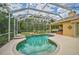 The large screened-in pool and spa are surrounded by lush landscaping at 14526 17Th E Ave, Bradenton, FL 34212
