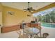 Covered patio and screened-in pool area includes an outdoor kitchen with a grill and a dining table at 14526 17Th E Ave, Bradenton, FL 34212