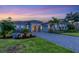 Two-story house with landscaped yard at sunset at 14728 Derna Ter, Lakewood Ranch, FL 34211