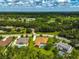 An aerial view showcasing a neighborhood with houses, lush greenery, and a tranquil atmosphere at 14526 17Th E Ave, Bradenton, FL 34212