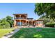 Back view of two-story home showcasing pool and patio area at 1502 Siesta Dr, Sarasota, FL 34239