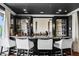 Modern home bar with a granite countertop and wine storage at 1502 Siesta Dr, Sarasota, FL 34239