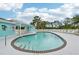 Community pool with lounge chairs and covered area at 1401 S Mccall Rd # 108A, Englewood, FL 34223