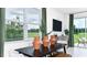 Dining area with black table and sliding glass doors at 3043 Novara Ln, Lakewood Ranch, FL 34211