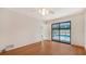 Bedroom with wood-look floors and sliding glass doors to the pool at 631 Venice Ln, Sarasota, FL 34242