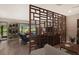 Living room with room divider and access to patio at 7301 Ballantrae Pl # 27D, Sarasota, FL 34238