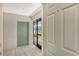 Inviting entryway with light flooring and access to a screened porch at 7301 Ballantrae Pl # 27D, Sarasota, FL 34238