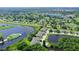 Aerial view of community featuring golf course, lake, and numerous homes at 7301 Ballantrae Pl # 27D, Sarasota, FL 34238