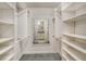 Large walk-in closet with ample shelving and hanging space at 7301 Ballantrae Pl # 27D, Sarasota, FL 34238