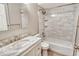 Clean bathroom with a bathtub, tiled walls, and marble vanity at 7301 Ballantrae Pl # 27D, Sarasota, FL 34238