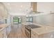 Modern kitchen with stainless steel appliances, white cabinets, and quartz countertops at 7301 Ballantrae Pl # 27D, Sarasota, FL 34238