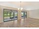 Dining room with wood-look floors and sliding glass doors at 7301 Ballantrae Pl # 27D, Sarasota, FL 34238