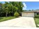 Two-car garage with driveway and lush landscaping at 7301 Ballantrae Pl # 27D, Sarasota, FL 34238