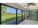 Spacious screened patio overlooking a lush green landscape and serene waterway at 7301 Ballantrae Pl # 27D, Sarasota, FL 34238