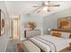 Bedroom with king-size bed, neutral decor, and ceiling fan at 7301 Ballantrae Pl # 27D, Sarasota, FL 34238