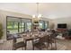 Bright dining area with table and chairs, view to living room and sliding doors to patio at 7301 Ballantrae Pl # 27D, Sarasota, FL 34238