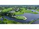 Aerial view of golf course community with lush landscaping and waterways at 7301 Ballantrae Pl # 27D, Sarasota, FL 34238