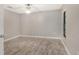 Simple bedroom with light gray walls and wood-look flooring at 7301 Ballantrae Pl # 27D, Sarasota, FL 34238