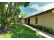 Home's backyard, showcasing lush landscaping and large tree at 7301 Ballantrae Pl # 27D, Sarasota, FL 34238