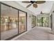 Spacious screened porch with tile floors and ceiling fans at 7301 Ballantrae Pl # 27D, Sarasota, FL 34238