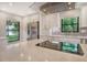 Modern kitchen with stainless steel appliances, white cabinets, and quartz countertops at 7301 Ballantrae Pl # 27D, Sarasota, FL 34238