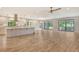 Open concept living room with kitchen and view to backyard at 7301 Ballantrae Pl # 27D, Sarasota, FL 34238