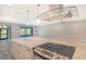 Modern kitchen featuring a large island with cooktop and stainless steel appliances at 7301 Ballantrae Pl # 27D, Sarasota, FL 34238