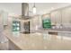 Modern kitchen with stainless steel appliances, white cabinets, and quartz countertops at 7301 Ballantrae Pl # 27D, Sarasota, FL 34238