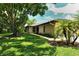 Landscaped backyard featuring mature trees and walkway at 7301 Ballantrae Pl # 27D, Sarasota, FL 34238