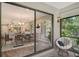 Relaxing patio view showcasing a comfortable chair and a glimpse of the modern kitchen at 7301 Ballantrae Pl # 27D, Sarasota, FL 34238