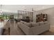 Open living room with sectional sofa and room divider at 7301 Ballantrae Pl # 27D, Sarasota, FL 34238