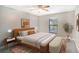 Bright bedroom with a king-size bed, stylish decor, and ceiling fan at 7301 Ballantrae Pl # 27D, Sarasota, FL 34238