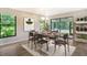 Modern staged dining room, featuring a wood table and chairs at 7301 Ballantrae Pl # 27D, Sarasota, FL 34238