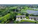 Aerial view showcasing the property's location near a golf course and lake at 7301 Ballantrae Pl # 27D, Sarasota, FL 34238